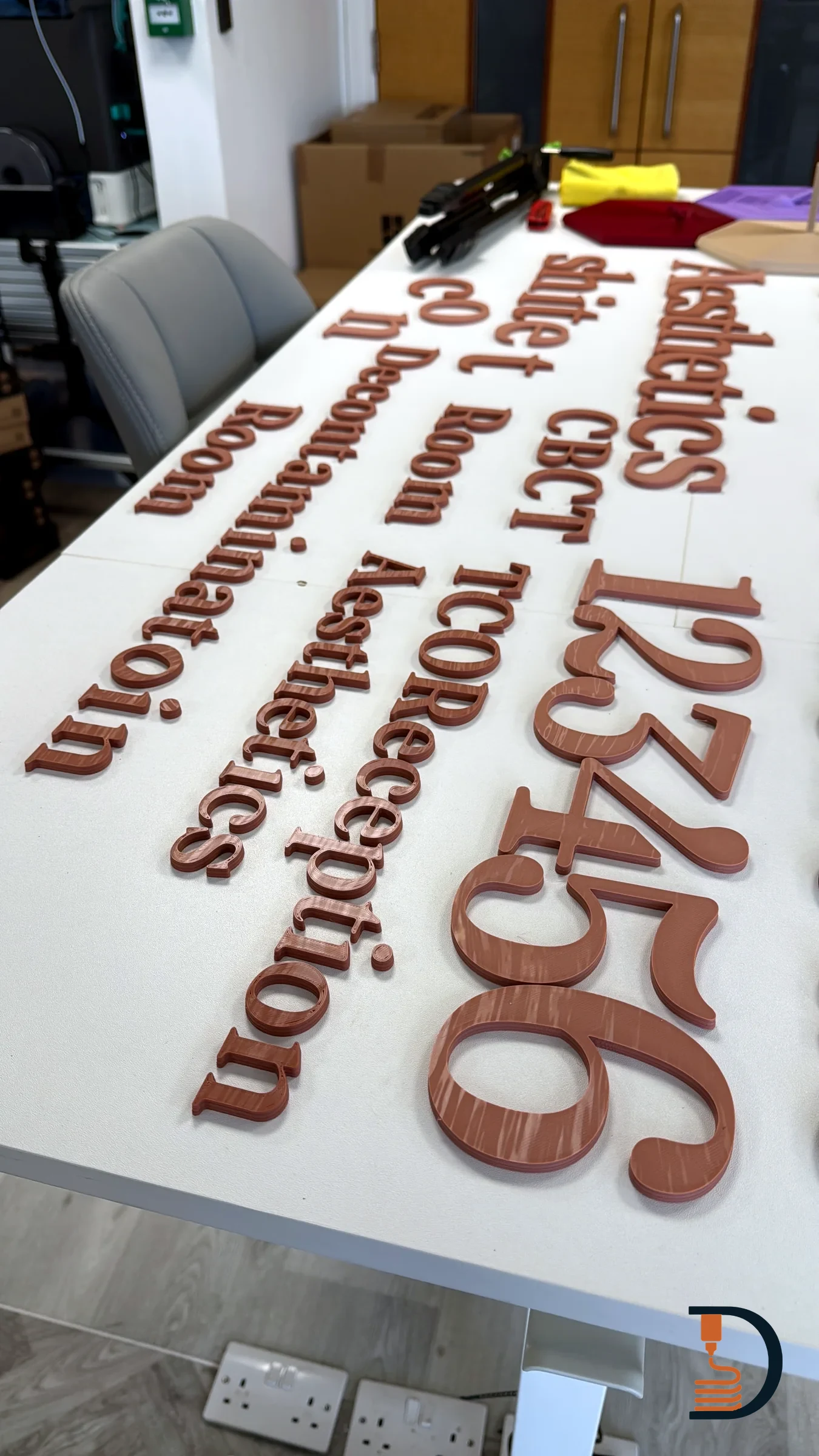 A full set of practice lettering laid out on the bench